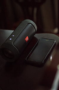 black JBL Charge 2 beside black iPhone 7 thumbnail