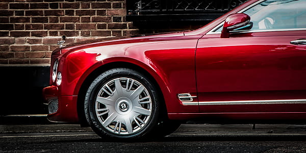 red Bentley Continental parked on roadside at daytime thumbnail