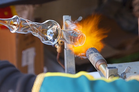 person molding glass on torch thumbnail