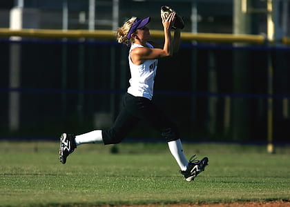 Woman in White Sleeveless Shirt Playing Softball thumbnail