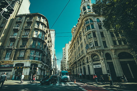 people walking on intersection surrounded by buildings thumbnail