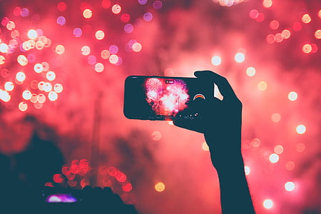 person taking photo of fireworks thumbnail
