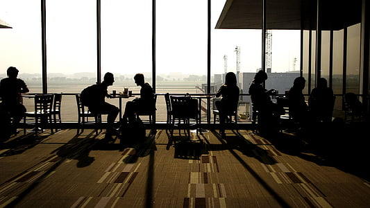 silhouette of people sitting on chair beside glass wall thumbnail