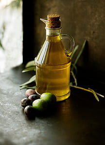 close-up photo of almost full glass bottle on black surface thumbnail