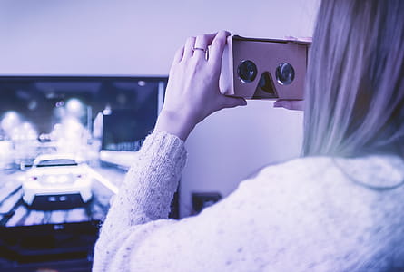 Girl uses cardboard for virtual reality at home thumbnail