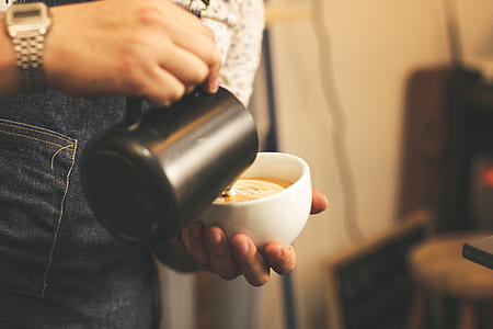 person pouring coffee on cup thumbnail