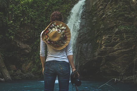 woman standing in front of waterfalls thumbnail