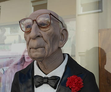wax statue of old man wearing eyeglasses thumbnail