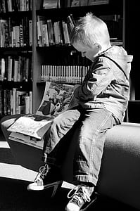 grayscale photography of boy sitting on sofa thumbnail