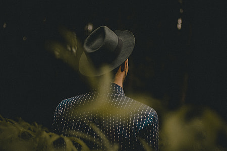 focus photo of person in blue and white collared top with hat thumbnail