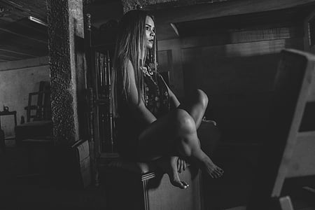 grayscale photo of woman sitting on chest thumbnail