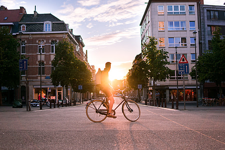 man on bicycle on the road during sunset thumbnail