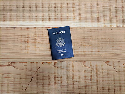 black Passport on brown wooden planks thumbnail