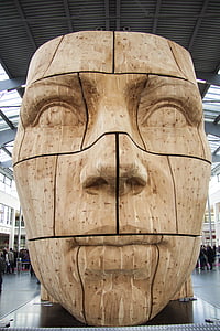 brown wooden statue of man's face thumbnail