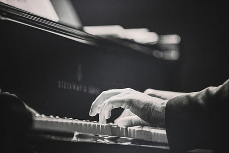 grayscale photography of person playing piano thumbnail