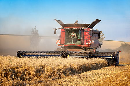 person driving harvester truck during daytime thumbnail