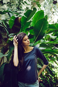 woman standing under plant photo thumbnail