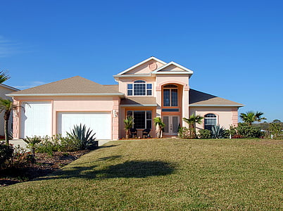 pink and white concrete house near trees thumbnail