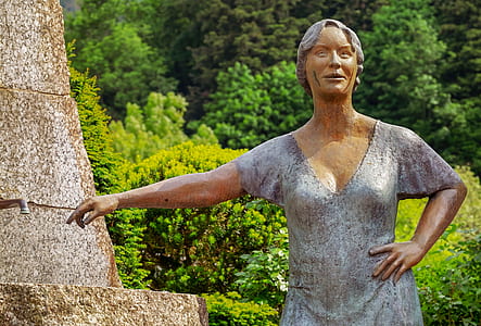 standing woman in gray V-neck shirt statue thumbnail