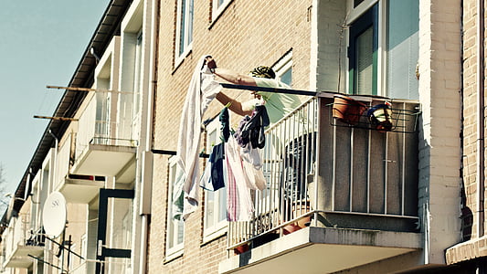 man holding white textile on terrace thumbnail