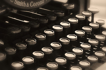 black and gray typewriter in closeup photography thumbnail