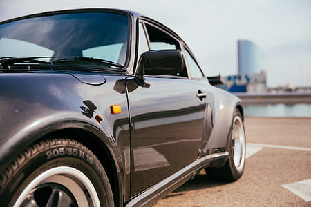 Side view of a black sports car with single door thumbnail