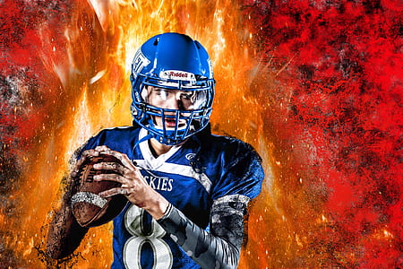 football athlete in full uniform holding football thumbnail