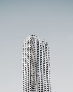 photo of gray concrete high-rise building under cloudy sky thumbnail