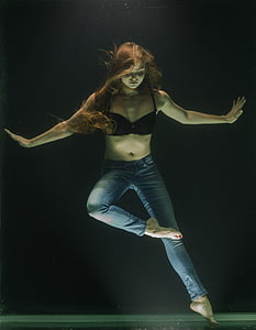 woman standing both arms sideways and right foot reaching left knee thumbnail