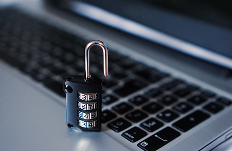 unlock black and grey numerical combination padlock placed on grey laptop thumbnail