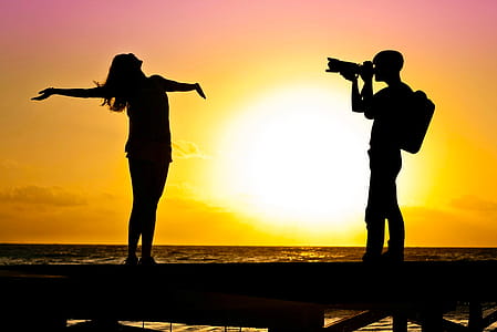 Photo illustration of photographer shooting photo of model on the beach. thumbnail