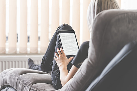 Young Woman Reading eBooks on Her iPad Tablet thumbnail