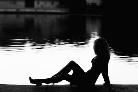 silhouette of woman over dock grayscale photo thumbnail