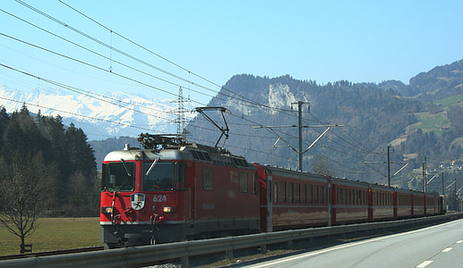 red and gray train under blue sky during daytime thumbnail