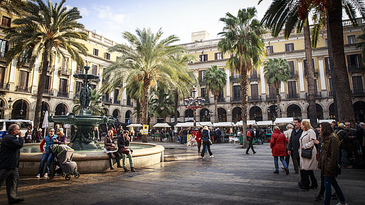 photo of people walking near building and palm trees thumbnail