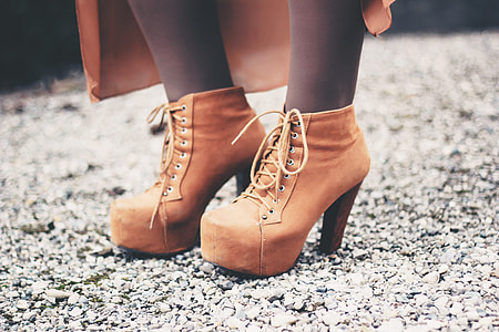 Closeup shot of a woman’s feet and brown boots thumbnail