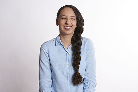 smiling woman wearing blue collared button-up long-sleeved top thumbnail