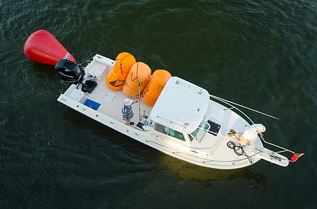 aerial photography of white motor boat on body of water thumbnail