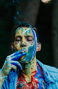 man smoking with paint on his face thumbnail