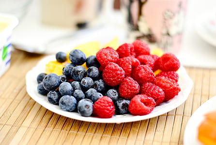 shallow focus photography of bluberries and cranberries thumbnail