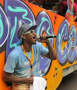 man singing beside orange bus thumbnail