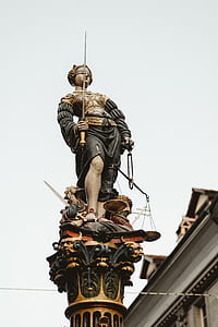 woman holding scale and sword statue low angle photography thumbnail