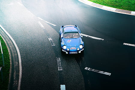 blue vehicle on road thumbnail