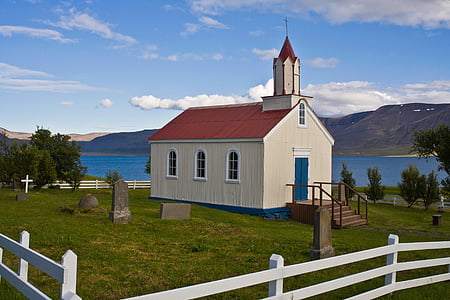 white and red chapel near lake at daytime thumbnail