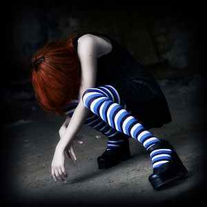 woman in black dress with pair of blue and white striped socks anime thumbnail