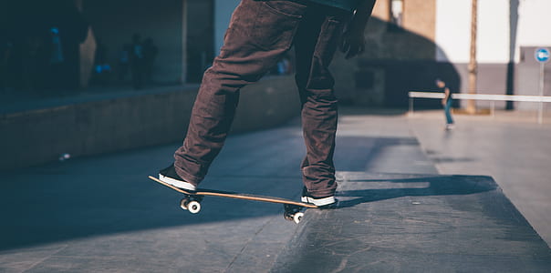 person doing skateboard trick during daytime thumbnail