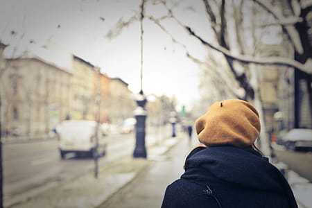 Person With Brown Hat Walking on Street thumbnail