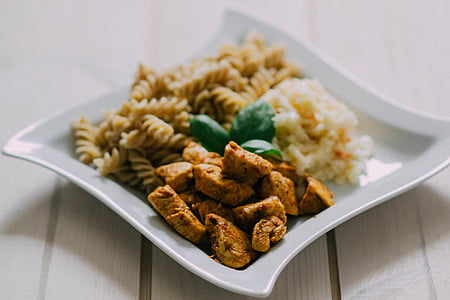 curl pasta, rice and meat on white ceramic plate thumbnail