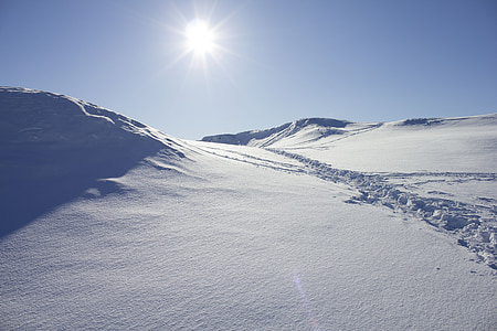 sun over snow covered mountains thumbnail