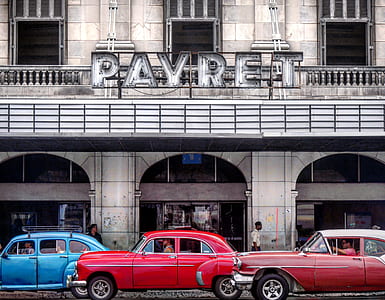 red and blue cars near building thumbnail